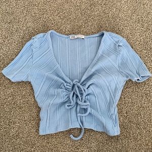 Small light blue crop top from Zara.